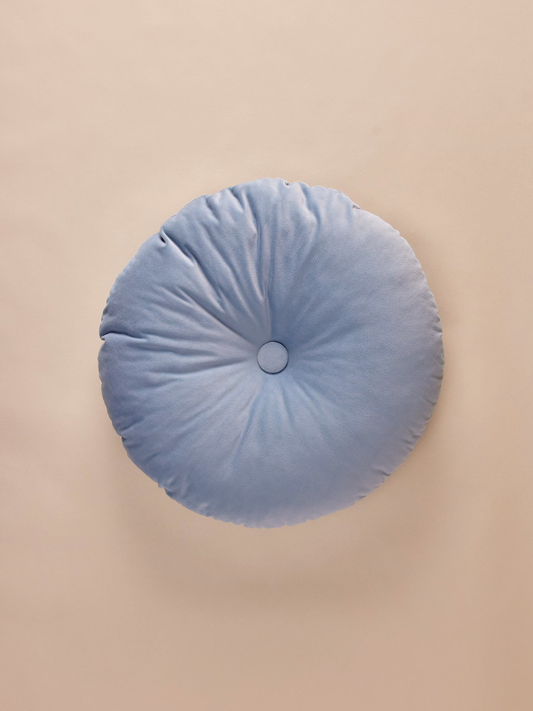 Round blue velvet pillow with decorative button
