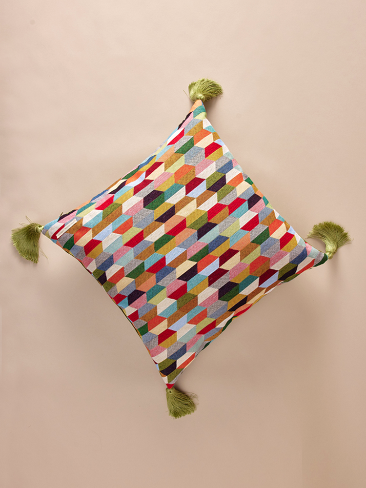 Velvet pillowcase with geometric pattern and decorative tassels.