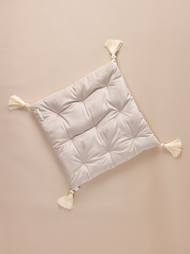 Square velvet pillow with decorative tassels