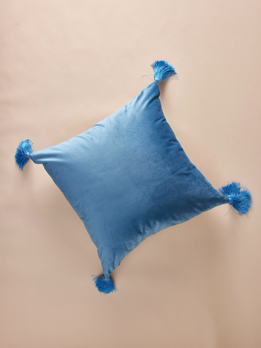 Velvet pillowcase with geometric pattern and decorative tassels.