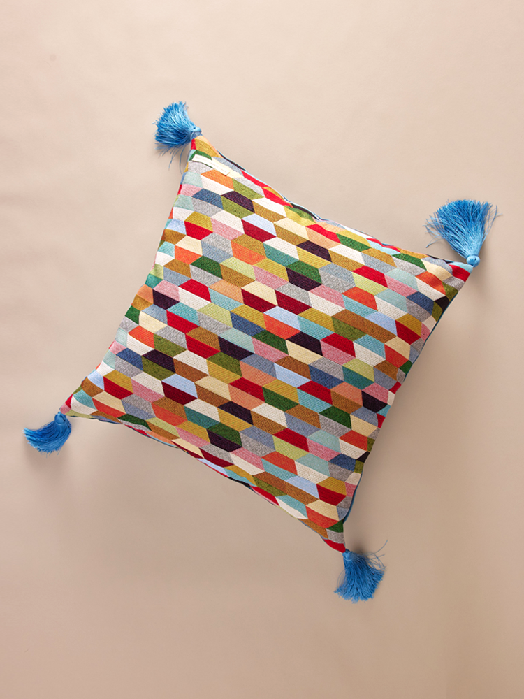 Velvet pillowcase with geometric pattern and decorative tassels.