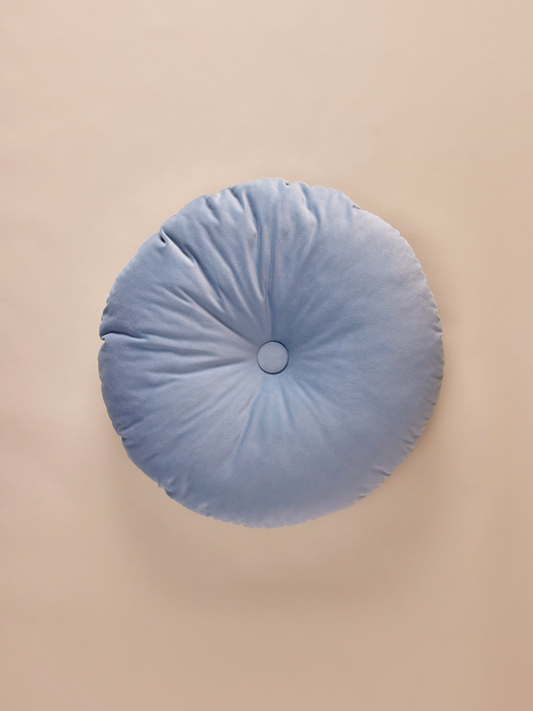 Round blue velvet pillow with decorative button