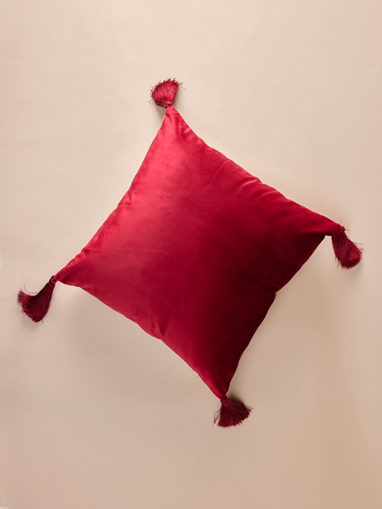 Velvet pillowcase with geometric pattern and decorative tassels.