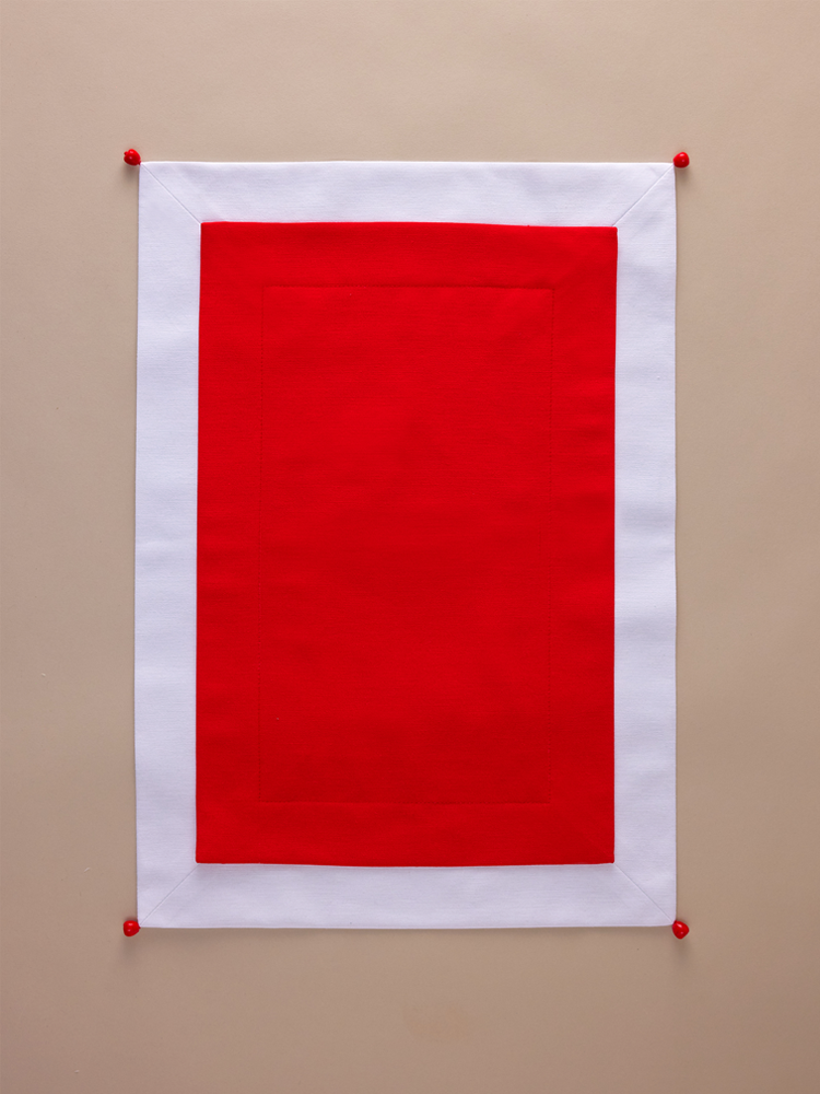 Red placemat with white edging