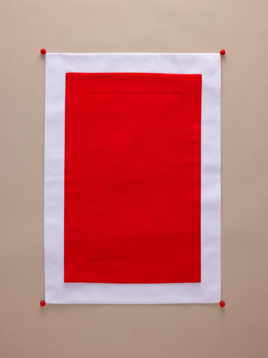Red placemat with white edging