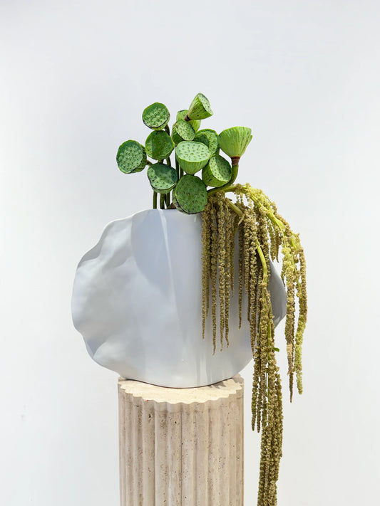 Flower delivery in Dubai: The verdant still life arrangement in a sculptural white vase