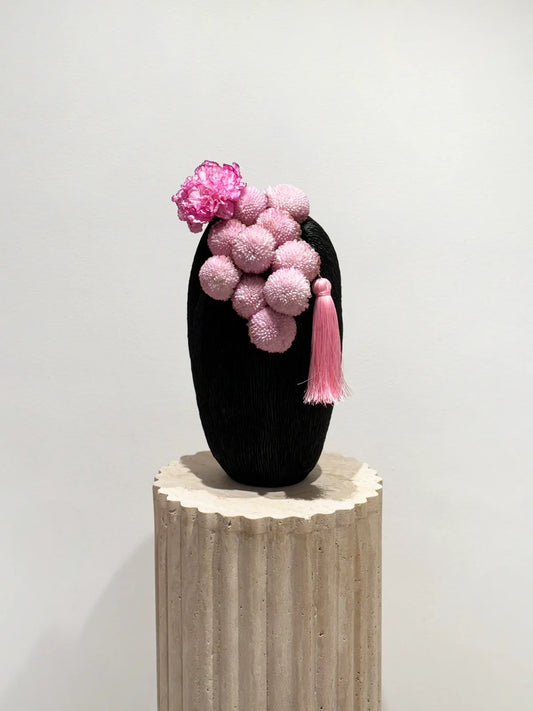 Flower delivery in Dubai: The unique whimsical wonder arrangement in a sleek, dark vessel